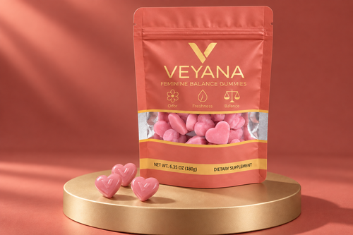 VEYANA Feminine Balance Gummies in a muted coral pouch with a gold V logo, pink heart-shaped gummies and a gold pedestal.