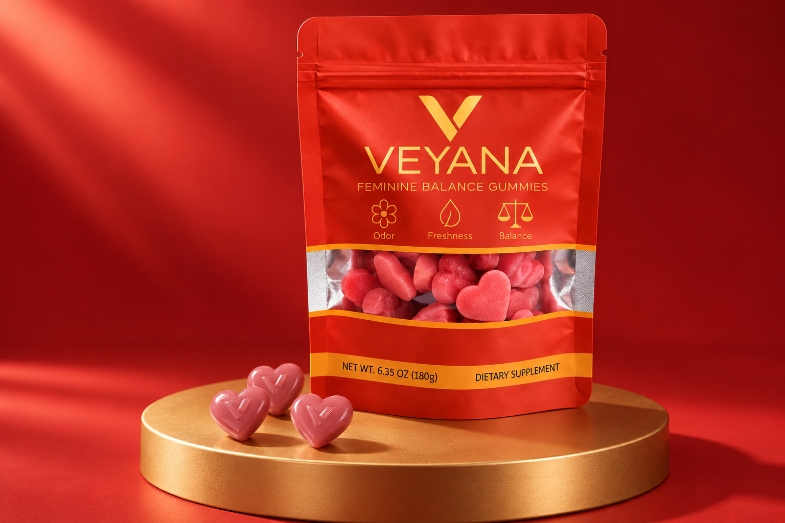 VEYANA red and gold pouch with heart gummies on a gold studio pedestal